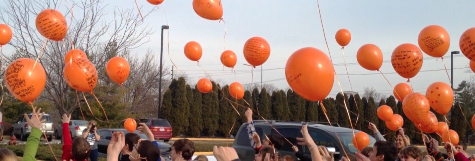 People releasing red balloons